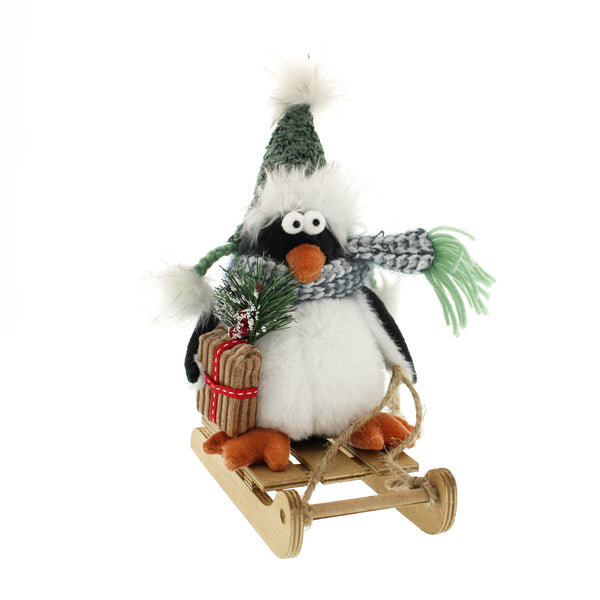 Penguin black/white plush sitting on sleigh 26cm