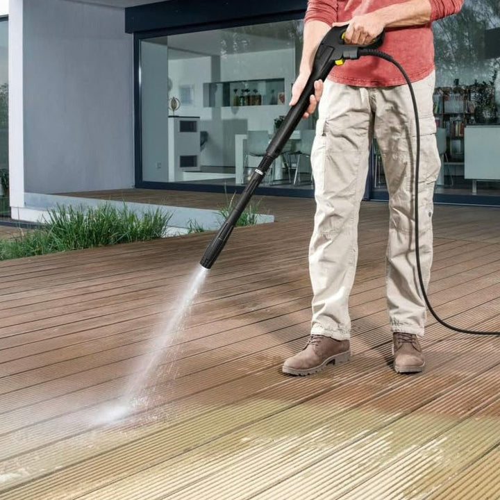 Man powerwashing his decking with Kärcher HK 7.5 High-Pressure Hose Kit
